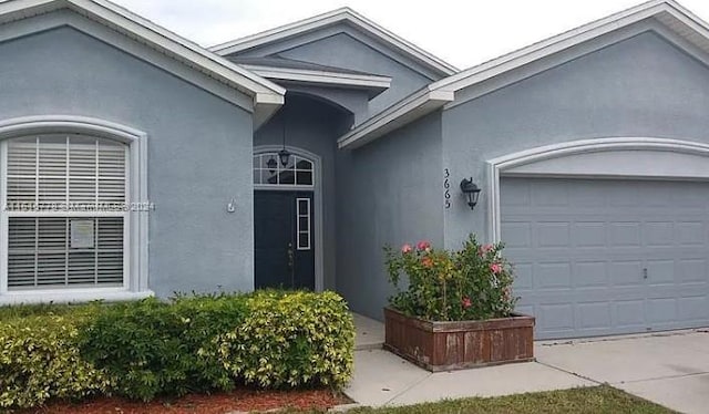 doorway to property featuring a garage