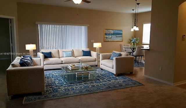 carpeted living room with ceiling fan