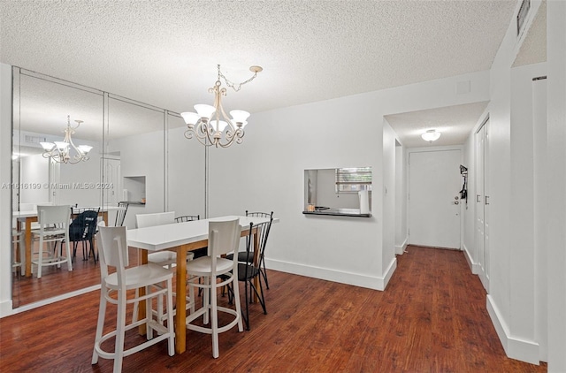 dining area with dark hardwood / wood-style flooring, a chandelier, and a textured ceiling