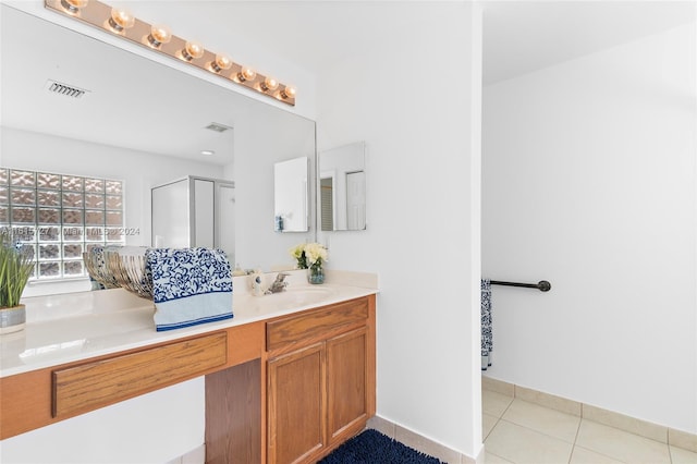 bathroom featuring tile patterned flooring and vanity