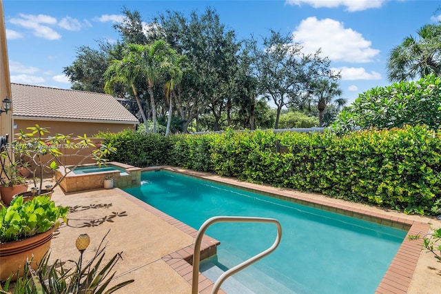 view of pool featuring an in ground hot tub