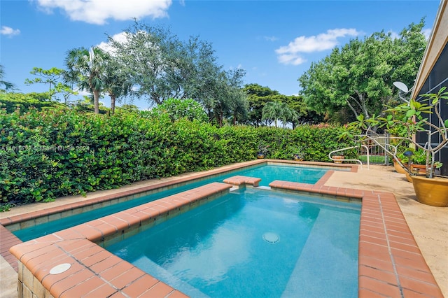 view of pool with an in ground hot tub