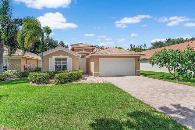 mediterranean / spanish-style house featuring a garage and a front yard