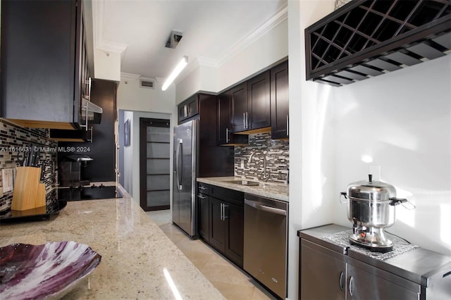 kitchen featuring sink, appliances with stainless steel finishes, dark brown cabinets, light tile patterned flooring, and light stone counters