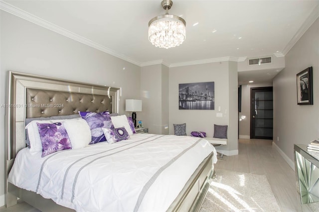 bedroom featuring light hardwood / wood-style floors, crown molding, and a chandelier