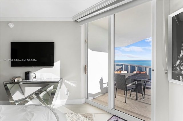 tiled bedroom with a water view and ornamental molding