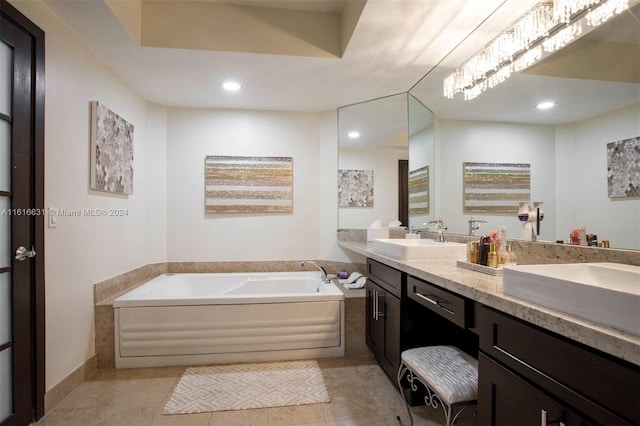 bathroom featuring a washtub, vanity, and tile patterned flooring