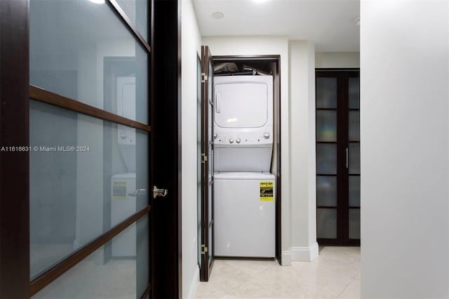 washroom with stacked washer / drying machine