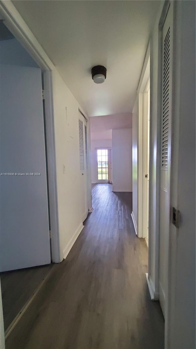 corridor featuring dark hardwood / wood-style floors