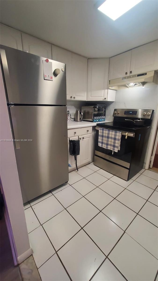 kitchen featuring white cabinetry, appliances with stainless steel finishes, and light tile patterned flooring