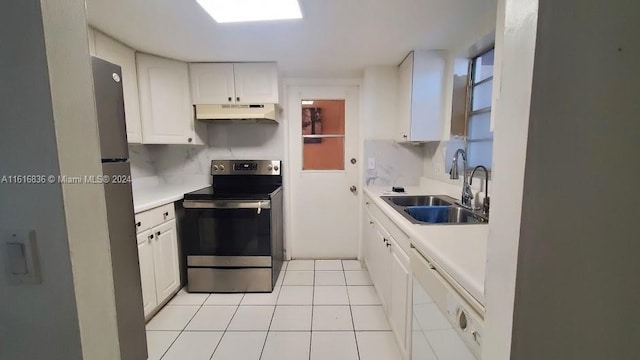 kitchen with sink, white cabinets, backsplash, light tile patterned floors, and stainless steel appliances