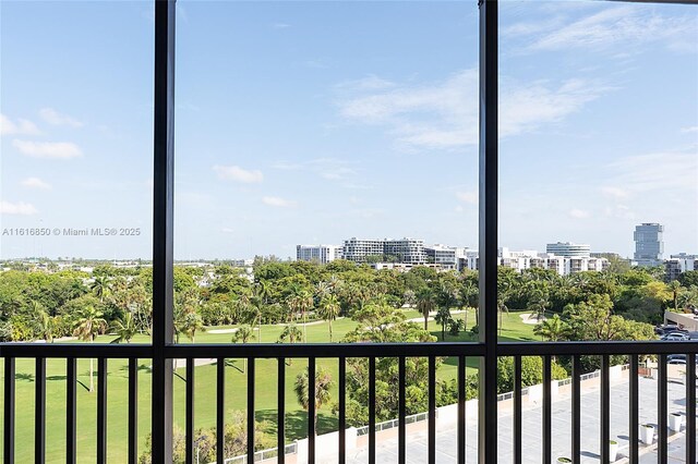 spare room featuring expansive windows and light hardwood / wood-style floors