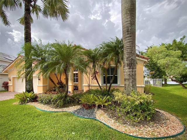 view of property exterior with a garage and a yard