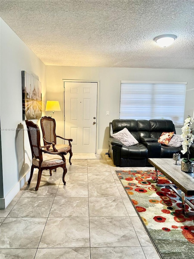 living room featuring light tile patterned floors and a textured ceiling