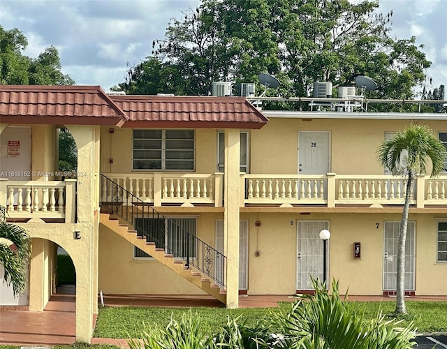 back of property featuring a balcony and cooling unit