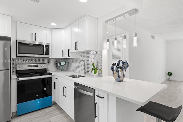 kitchen with white cabinetry, appliances with stainless steel finishes, and sink