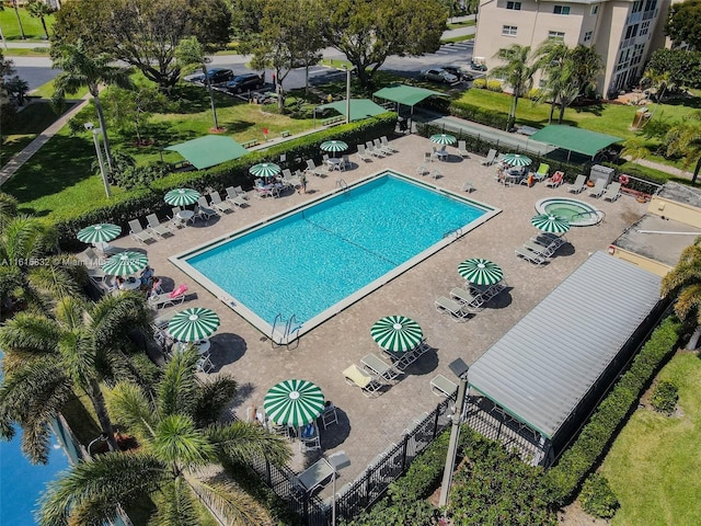 view of pool with a hot tub and a patio