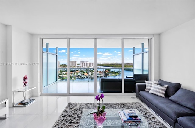 living room with a water view, light tile patterned floors, and a wealth of natural light