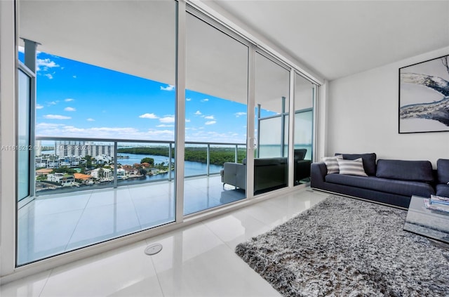 living room featuring a water view and a wall of windows