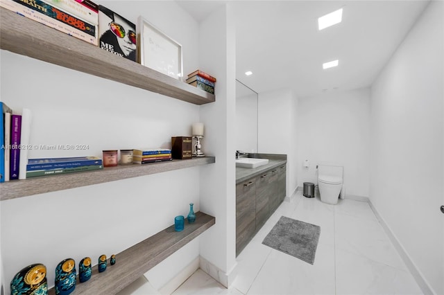 bathroom featuring vanity, toilet, and tile patterned flooring