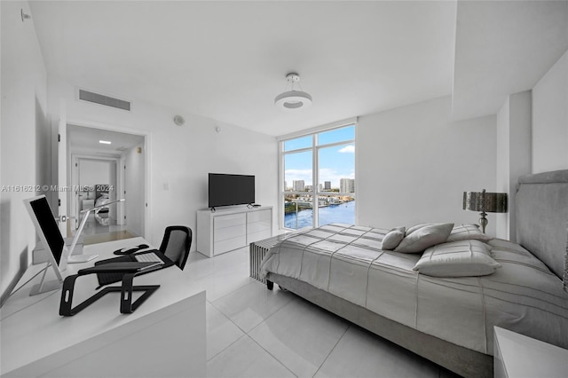 tiled bedroom featuring floor to ceiling windows