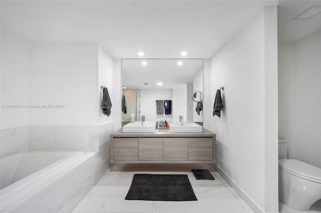 bathroom with vanity, toilet, and a bathtub