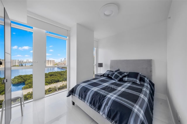 tiled bedroom with a water view