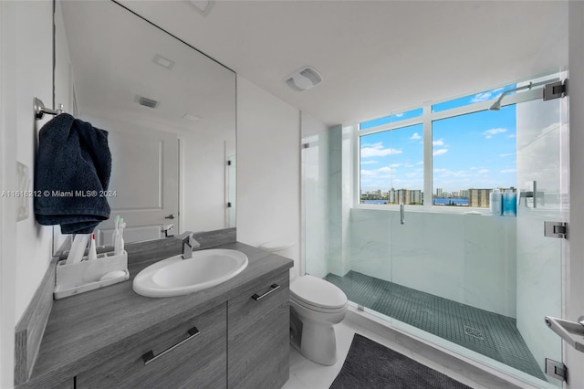 bathroom featuring vanity, a shower with door, and toilet