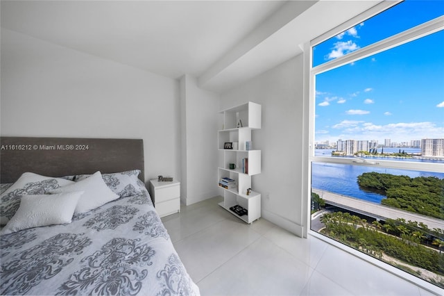 tiled bedroom featuring a water view