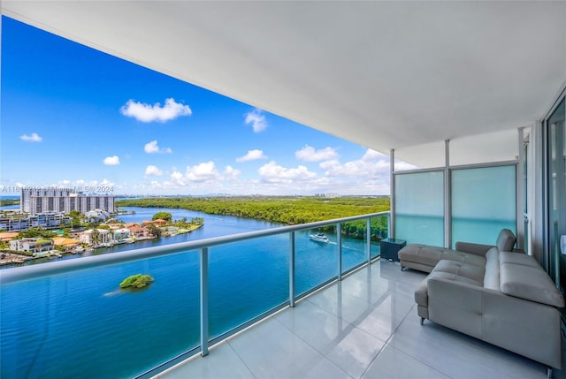 balcony with a water view and an outdoor living space