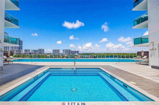 view of swimming pool with a patio area