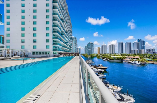 view of pool featuring a water view