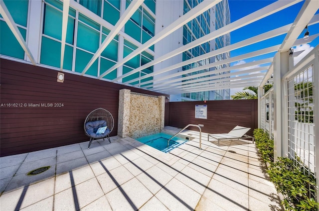 view of patio featuring an in ground hot tub