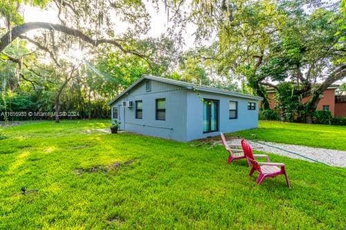 rear view of property featuring a yard