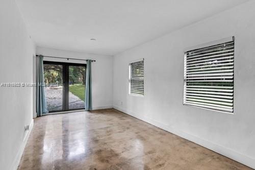 unfurnished room featuring concrete floors