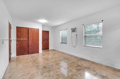 unfurnished bedroom with a closet and concrete flooring