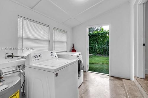 washroom featuring water heater and washer and dryer