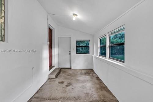 corridor featuring lofted ceiling