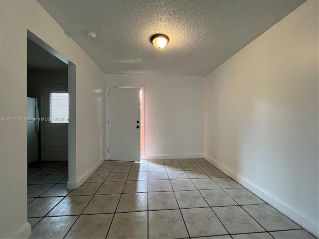 tiled foyer with a textured ceiling