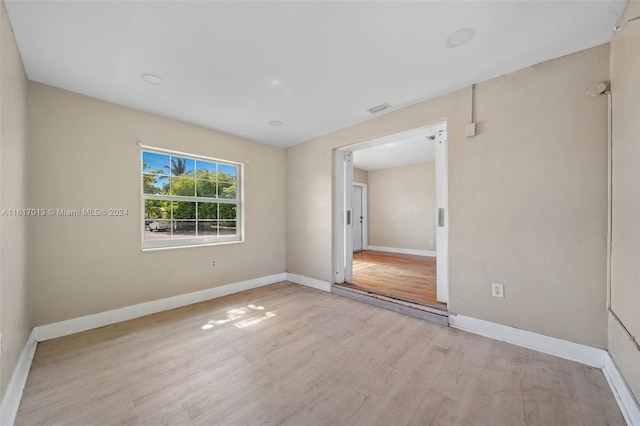 spare room featuring light hardwood / wood-style floors