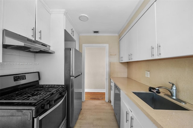 1400 SW 62nd Ave, West Miami, FL 33144 - kitchen with stainless steel appliances, under cabinet range hood, white cabinetry, decorative backsplash, and crown molding