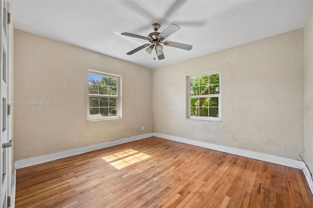 unfurnished room with hardwood / wood-style floors and ceiling fan