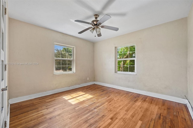 1400 SW 62nd Ave, West Miami, FL 33144 - empty room with healthy amount of natural light, wood-type flooring, and a ceiling fan