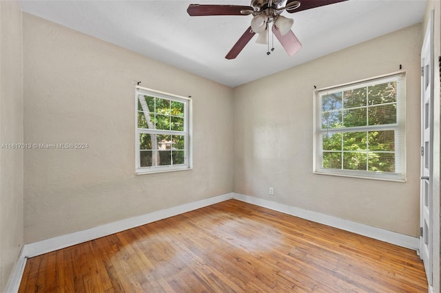 empty room featuring hardwood / wood-style flooring and ceiling fan