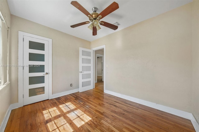 unfurnished bedroom featuring hardwood / wood-style floors and ceiling fan