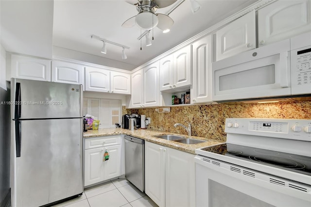 kitchen with light tile patterned floors, stainless steel appliances, white cabinets, and sink