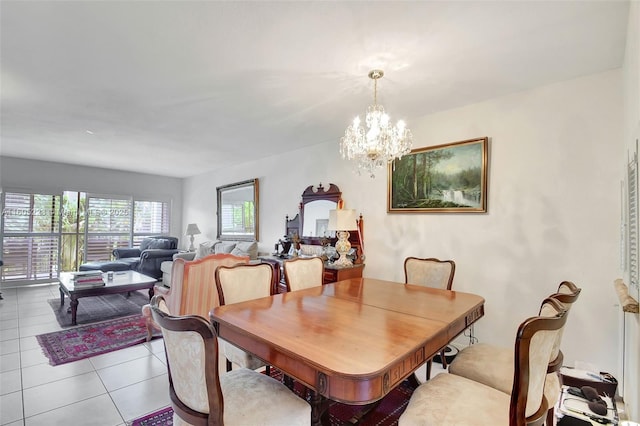 tiled dining room featuring a notable chandelier