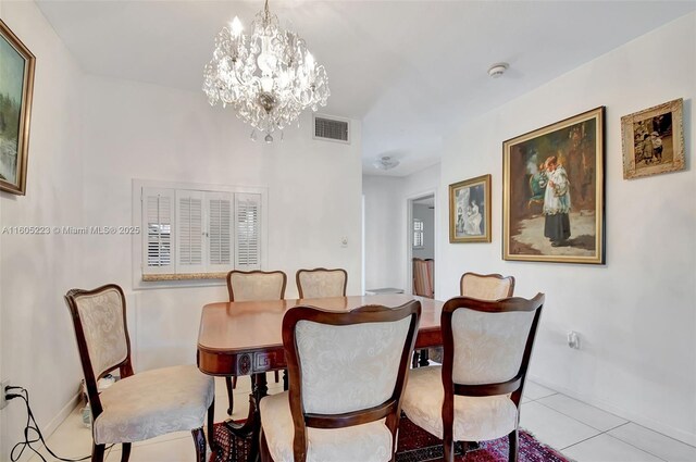 tiled dining space with a notable chandelier