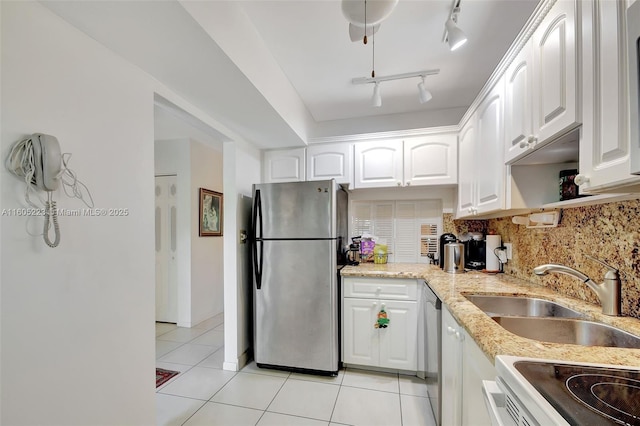 kitchen featuring stainless steel appliances, white cabinets, tasteful backsplash, and sink