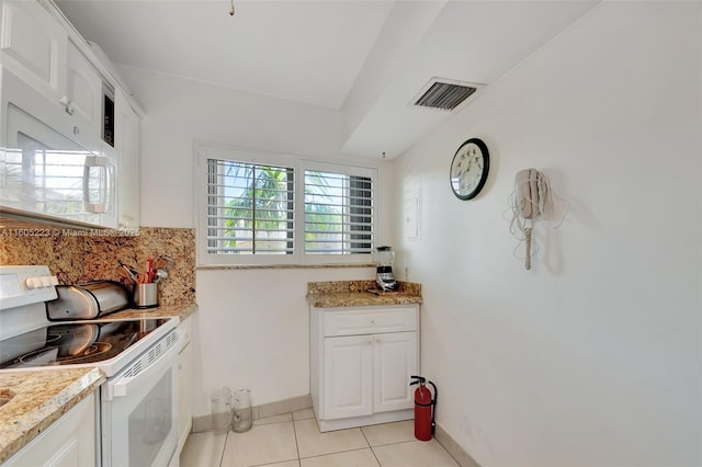 kitchen with light tile patterned floors, white cabinetry, decorative backsplash, and white appliances